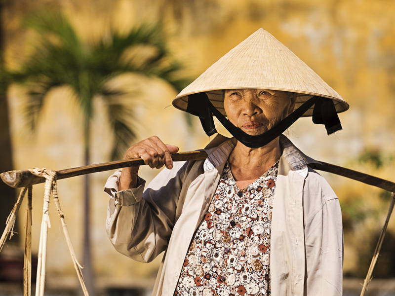 Une cultivatrice portant un chapeau